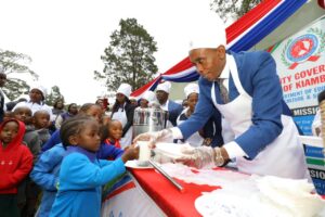 Kiambu Governor Dr Kimani Wamatangi participating in a feeding programme
