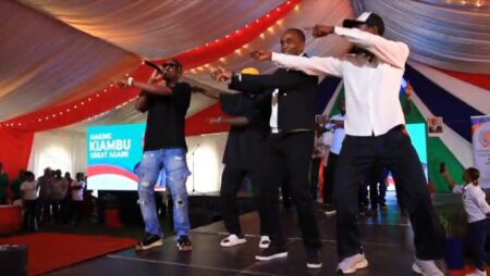 Governor Dr. Kimani Wamatangi, second right, join youth in a dance during the youth day festivals