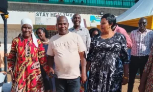 Chief Stephen Maina ( Centre) with his wife in black and mother on his right during the ceremony.