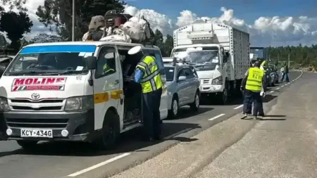 Travelers Praise Police Strategy for Smooth Traffic Flow on Nairobi-Nakuru Highway A traffic police officer from Lari police station inspecting a Public Service Vehicle on Christmas day at Nyambari area along the Nairobi Nakuru highway.
